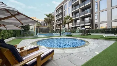 a swimming pool with a bench and a building at Upscale 2BR with Private Terrace & Pool View in Dubai