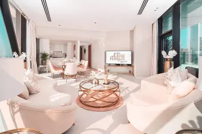 a living room with white chairs and a table at Elite Royal Apartment - Sky Series - Panoramic Burj Khalifa, Skyline & Fountain View - Admiral in Dubai