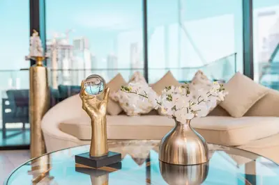 a living room with a coffee table with a gold trophy at Elite Royal Apartment - Sky Series - Panoramic Burj Khalifa, Skyline & Fountain View - Admiral in Dubai