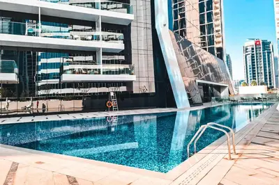 a swimming pool in front of a building at Elite Royal Apartment - Sky Series - Panoramic Burj Khalifa, Skyline & Fountain View - Admiral in Dubai
