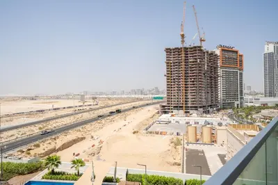 a view of a beach with buildings and condos at Stylish Studio with Pool View & Free Parking in Dubai