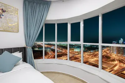 a bedroom with a large window with a city view at Stunning Panoramic Sea & Marina City Skyline View in Dubai