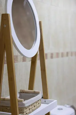 a mirror on a wooden stand next to a sink at Stunning Panoramic Sea & Marina City Skyline View in Dubai