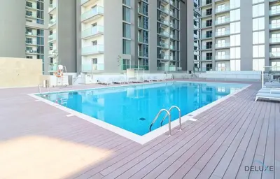 a swimming pool in the middle of a building at Charming 1BR Apartment in Sobha Creek Vistas Reserve, Al Merkadh by Deluxe Holiday Homes in Dubai