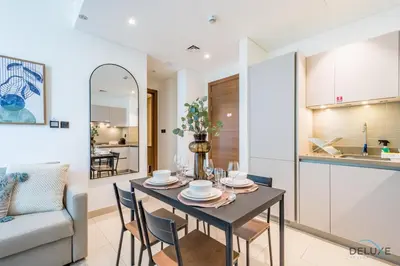 a dining room and kitchen with a table and chairs at Charming 1BR Apartment in Sobha Creek Vistas Reserve, Al Merkadh by Deluxe Holiday Homes in Dubai