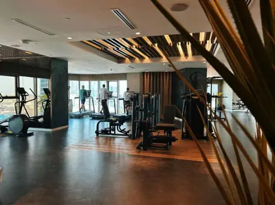a gym with treadmills and exercise equipment in a building at 64th Floor Highest Downtown Infinity Pool Burj Khalifa View in Dubai
