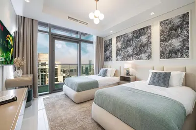 a bedroom with two beds and a desk and windows at 64th Floor Highest Downtown Infinity Pool Burj Khalifa View in Dubai
