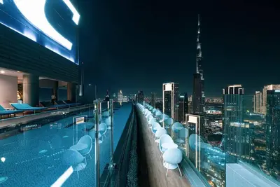 a rooftop swimming pool with a view of a city at 64th Floor Highest Downtown Infinity Pool Burj Khalifa View in Dubai