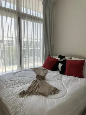 a bed with a stuffed panda bear sitting on it at Villa Townhouse in Dubai
