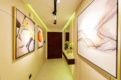 a hallway with paintings on the walls at VIP Experience Dubai Downtown at Boulevard Central T2 - Burj Khalifa View - Modern Luxury Apartments in Dubai