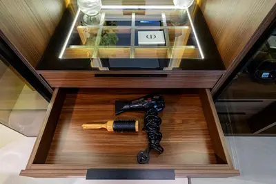 a glass box with a gun on a table at VIP Experience Dubai Downtown at Boulevard Central T2 - Burj Khalifa View - Modern Luxury Apartments in Dubai