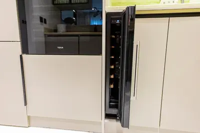 a microwave oven sitting inside of a white kitchen at VIP Experience Dubai Downtown at Boulevard Central T2 - Burj Khalifa View - Modern Luxury Apartments in Dubai
