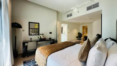 a bedroom with a bed and a desk in it at Damac Majestine VIP - Manzar Holiday Homes in Dubai