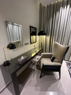 a living room with a desk and a chair at Damac Majestine VIP - Manzar Holiday Homes in Dubai