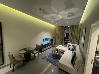 a living room with a couch and a table at Damac Majestine VIP - Manzar Holiday Homes in Dubai