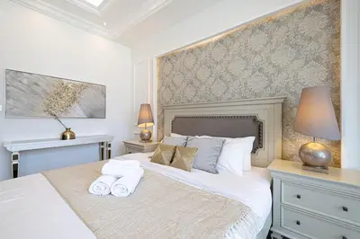 a bedroom with a large bed with towels on it at Classic Charm a Studio with Iconic Marina Views in Dubai