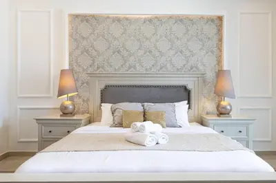 a bedroom with a large white bed with towels on it at Classic Charm a Studio with Iconic Marina Views in Dubai