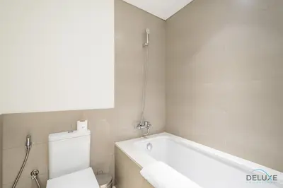 a bathroom with a white tub and a toilet at Captivating 2BR Apartment in Park Ridge Tower C , Dubai Hills Estate by Deluxe Holiday Homes in Dubai