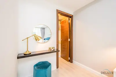 a room with a mirror and a blue stool at Stylish 1BR Apartment in Al Sahab 2, Dubai Marina by Deluxe Holiday Homes in Dubai
