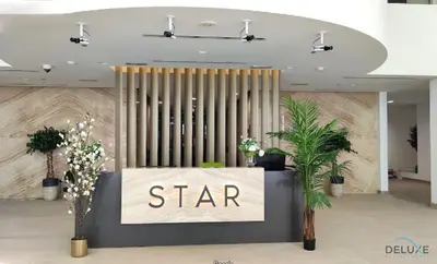 a star lobby with a star sign and plants at Stunning Studio Apartment in Azizi Star , Jebel Ali by Deluxe Holiday Homes in Dubai