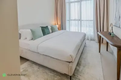 a large white bed in a room with a window at Clever Guest 027 Acacia A in Dubai