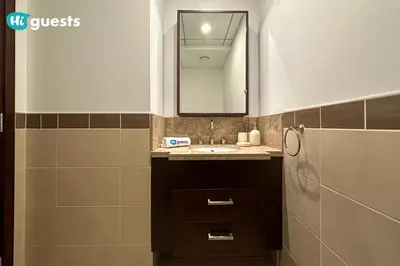 a bathroom with a sink and a mirror at HiGuests - Exclusive Downtown Dubai 1BR Apt at 29 Boulevard in Dubai