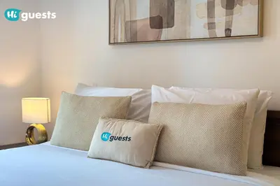 a bedroom with a bed with pillows on it at HiGuests - Exclusive Downtown Dubai 1BR Apt at 29 Boulevard in Dubai