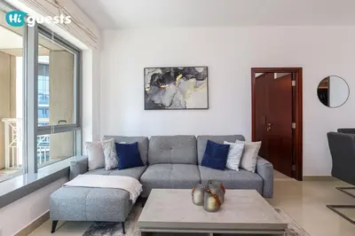 a living room with a couch and a table at HiGuests - Exclusive Downtown Dubai 1BR Apt at 29 Boulevard in Dubai
