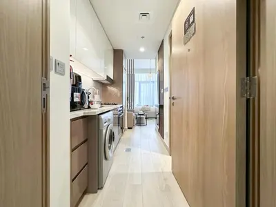 a kitchen with a washer and dryer in a room at Trophy Modern Marvel Cozy Studio with Smart Features in Azizi Riviera in Dubai