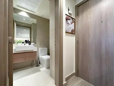 a bathroom with a sink and a toilet at Trophy Modern Marvel Cozy Studio with Smart Features in Azizi Riviera in Dubai