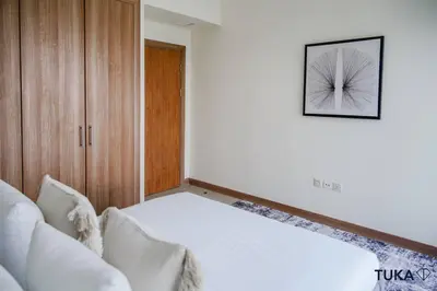 a bedroom with a white bed and a picture on the wall at 3-BHK - Dubai Marina - 44th Floor - 5mins to beach in Dubai