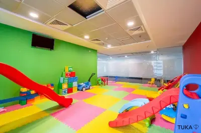 a childrens play room with a green wall at 3-BHK - Dubai Marina - 44th Floor - 5mins to beach in Dubai