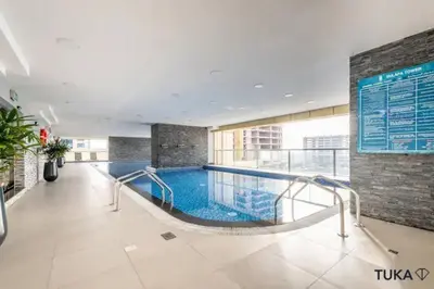 a large swimming pool in a building at 3-BHK - Dubai Marina - 44th Floor - 5mins to beach in Dubai