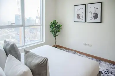 a bedroom with a white bed and a window at 3-BHK - Dubai Marina - 44th Floor - 5mins to beach in Dubai