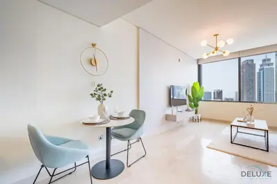 a living room with a table and chairs at Stylish Studio at Sky Gardens, DIFC by Deluxe Holiday Homes in Dubai