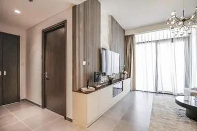 a living room with a flat screen tv on a wall at Trophy - Ultra Luxury Suite with Fireplace in Dubai