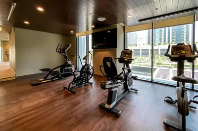 a gym with treadmills and exercise bikes in a room at Trophy - Ultra Luxury Suite with Fireplace in Dubai