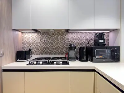 a kitchen with a stove and a microwave at Naseem - Stylish 1BR Hotel Apartment Overlooking the Marina in Dubai