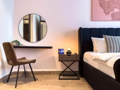 a bedroom with a bed and a mirror at Naseem - Stylish 1BR Hotel Apartment Overlooking the Marina in Dubai