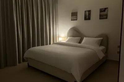 a bedroom with a white bed and a window at Stunning Burj Khalifa & Fountain view - Dubai Mall Access, Burj vista Downtown Dubai in Dubai