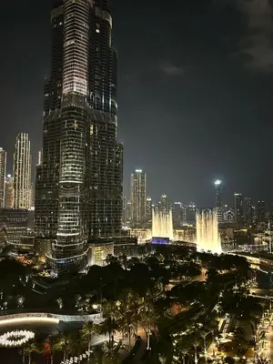 a city skyline at night with a tall building at Stunning Burj Khalifa & Fountain view - Dubai Mall Access, Burj vista Downtown Dubai in Dubai