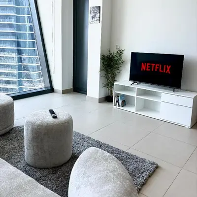 a living room with a tv and a couch at Stunning Burj Khalifa & Fountain view - Dubai Mall Access, Burj vista Downtown Dubai in Dubai
