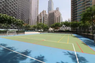 a tennis court in the middle of a city at Stunning Burj Khalifa & Fountain view - Dubai Mall Access, Burj vista Downtown Dubai in Dubai