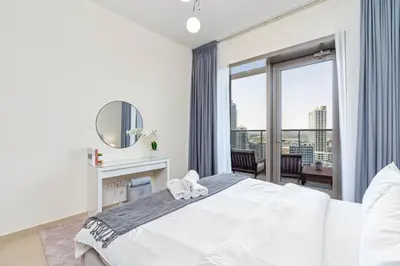 a bedroom with a large white bed and a large window at Gala Guests - Deluxe Sparkle Residences Dubai Marina in Dubai