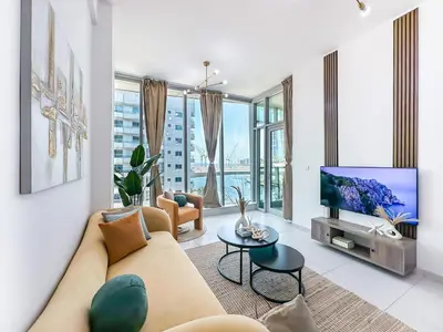a living room with a couch and a tv at Luxury RoofTop Pool with Full Marina View 45 percent OFF in Dubai