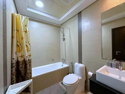 a bathroom with a toilet and a tub and a sink at Luxury RoofTop Pool with Full Marina View 45 percent OFF in Dubai