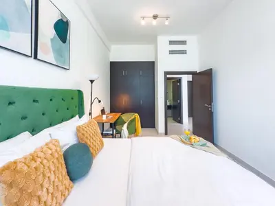 a large white bed with a green headboard in a room at Luxury RoofTop Pool with Full Marina View 45 percent OFF in Dubai