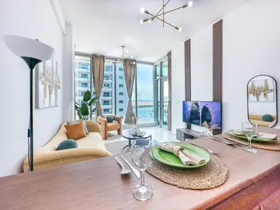 a living room with a dining table and a living room at Luxury RoofTop Pool with Full Marina View 45 percent OFF in Dubai
