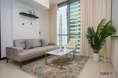a living room with a couch and a coffee table at Skyline & Lake views - Home Cinema - 1-BHK - Prime Location in Dubai