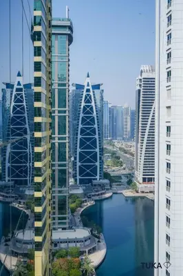 a view of a city with a river and buildings at Skyline & Lake views - Home Cinema - 1-BHK - Prime Location in Dubai